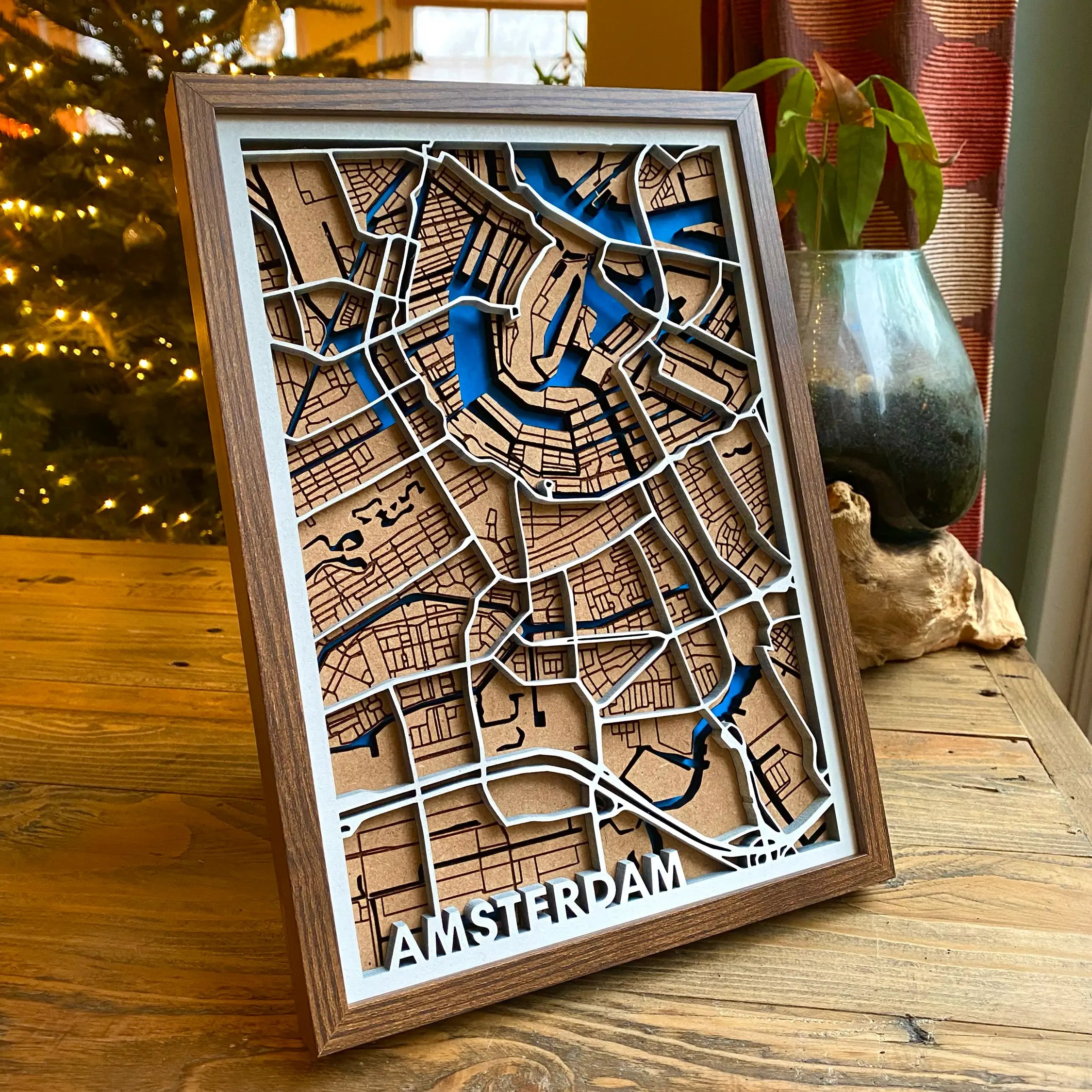 a 3D wooden map of Amsterdam sitting on a wooden coffee table